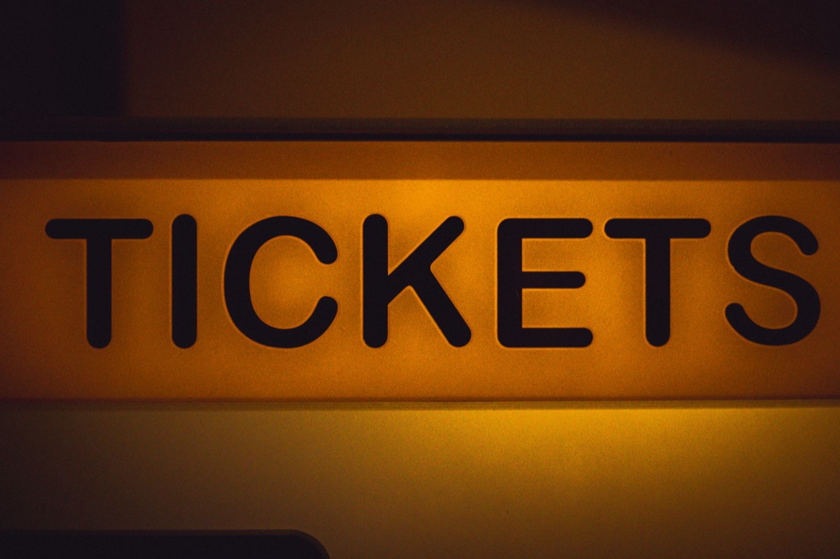 theater ticket window with brown paper tickets