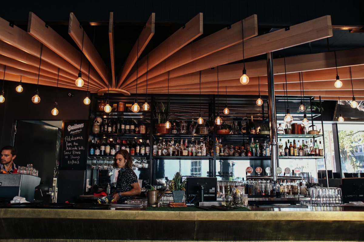 london pub interior with bar counter and waiting customers
